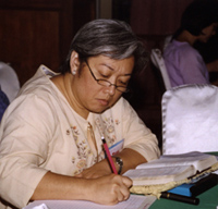 Tess Cusi, the Philippines, studies the book of Mark at the Thailand renewal in August, 2003.